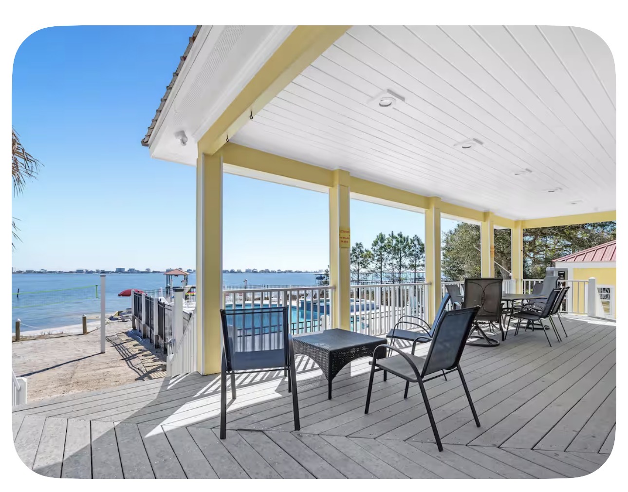 Covered porch seating with pool and lagoon views